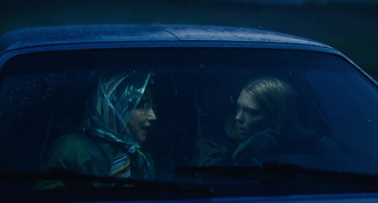 two women sitting in a car in the rain