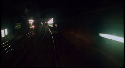 a train traveling down train tracks at night