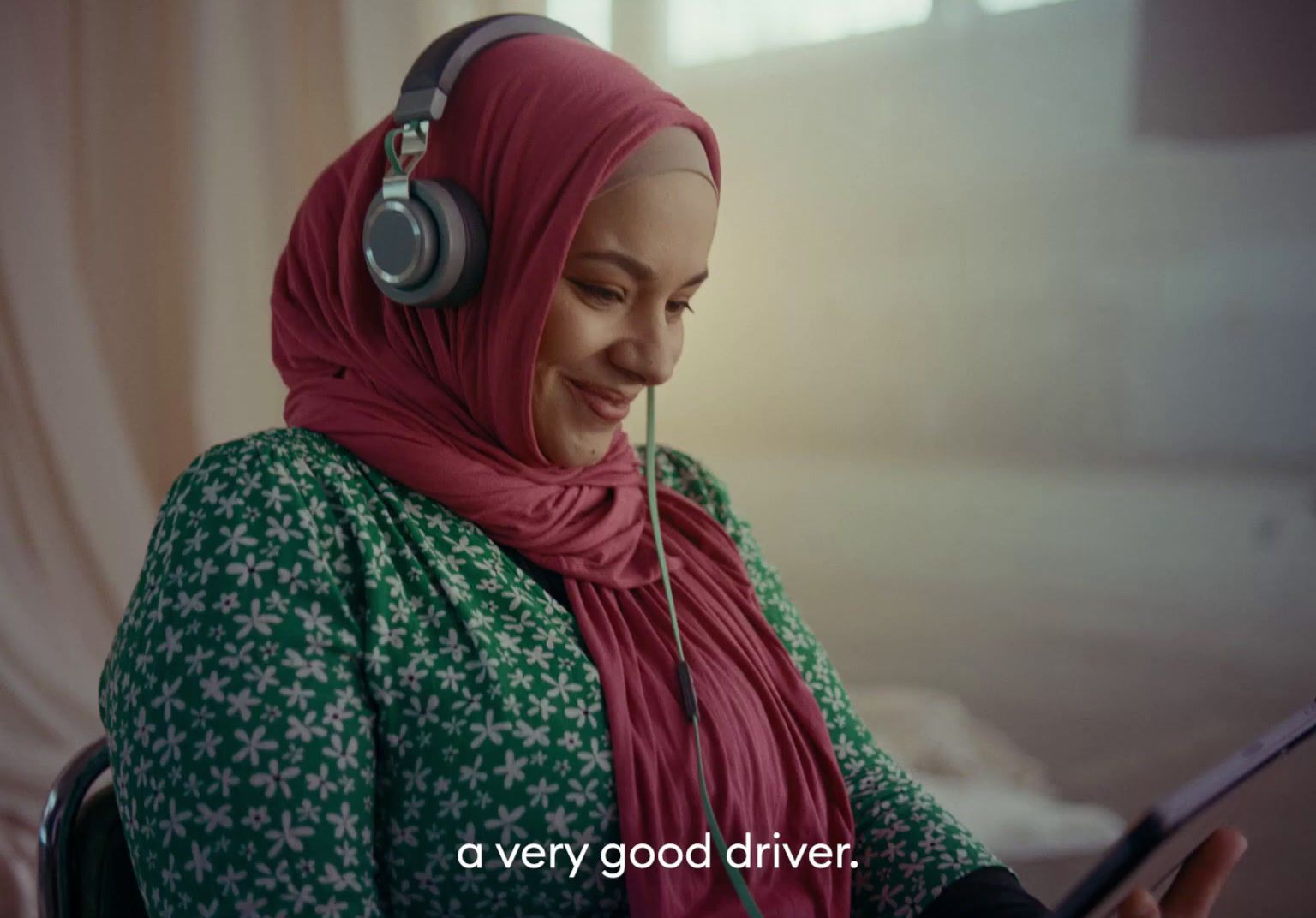 a woman wearing headphones and a pink scarf