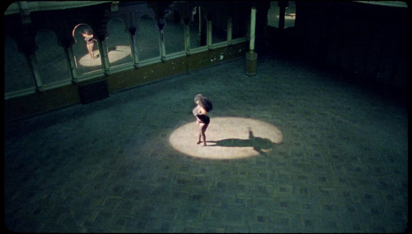 a person standing in a circle on a brick floor