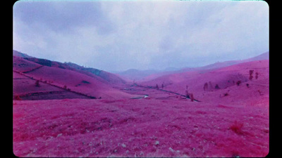 a view of a valley with mountains in the background