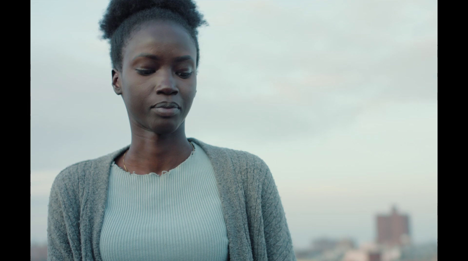 a woman looking down at her cell phone