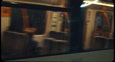 a blurry photo of a subway car with seats