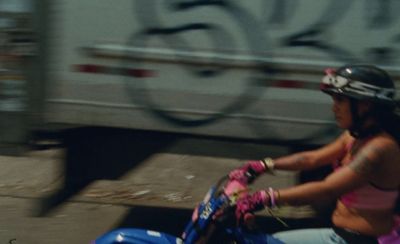 a woman riding a scooter on a city street