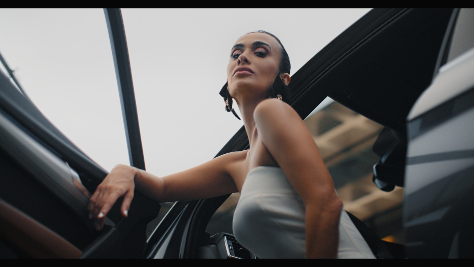 a woman leaning out of a car door