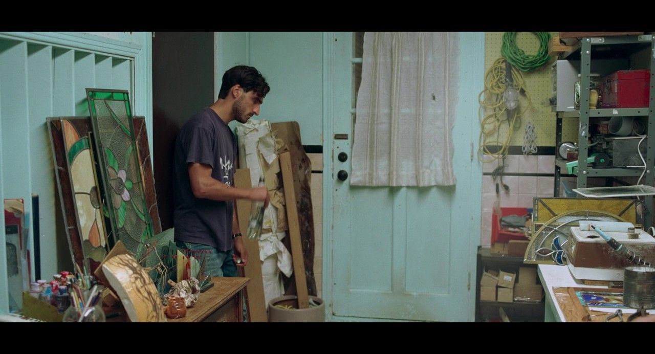 a man standing in front of a doorway next to a chair