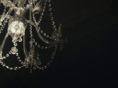 a chandelier hanging from a ceiling in a dark room