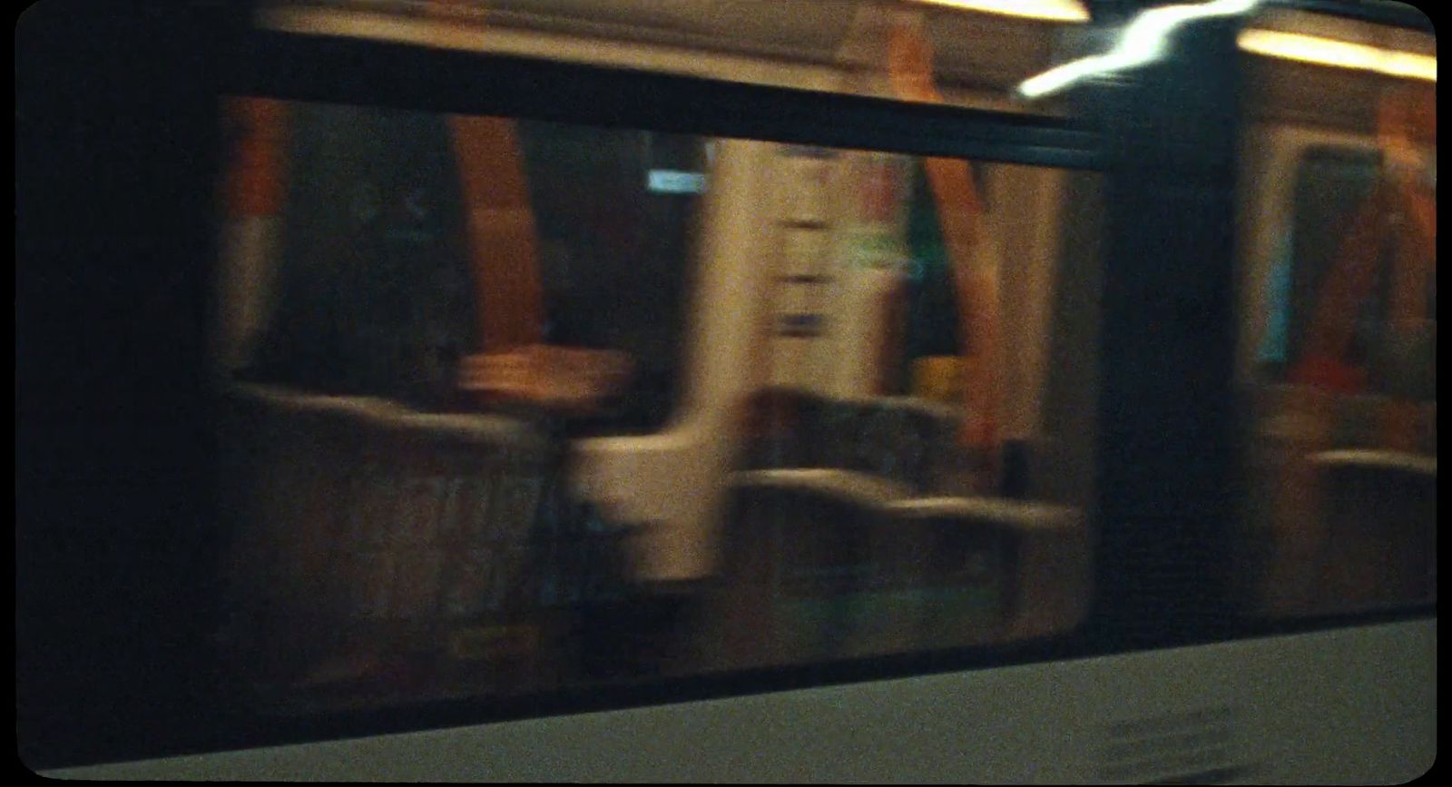 a blurry photo of a subway train with seats