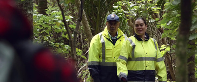 a couple of people that are standing in the woods