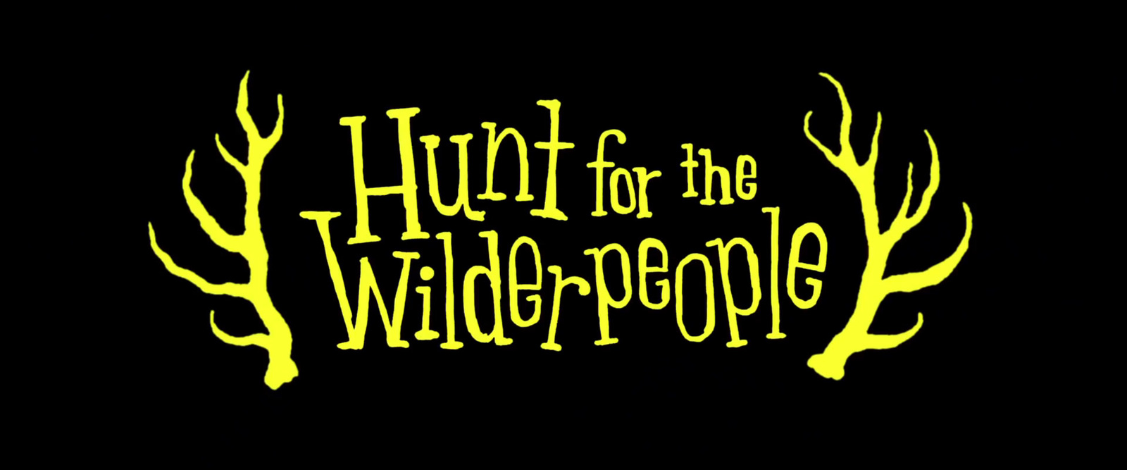 a black background with yellow lettering that says hunt for the wild people