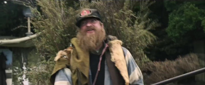 a man with a beard wearing a vest