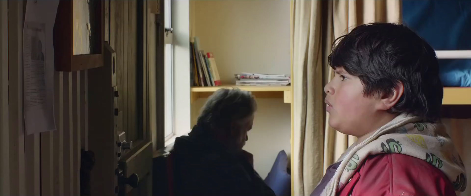 a woman standing next to a window in a room