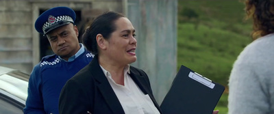 a woman in a police uniform holding a folder