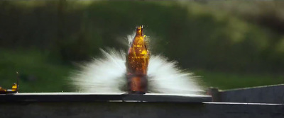 a bottle of beer is being thrown into the air