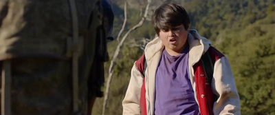 a boy in a purple shirt and a red and white jacket