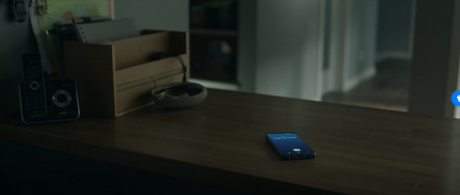 a cell phone sitting on top of a wooden table