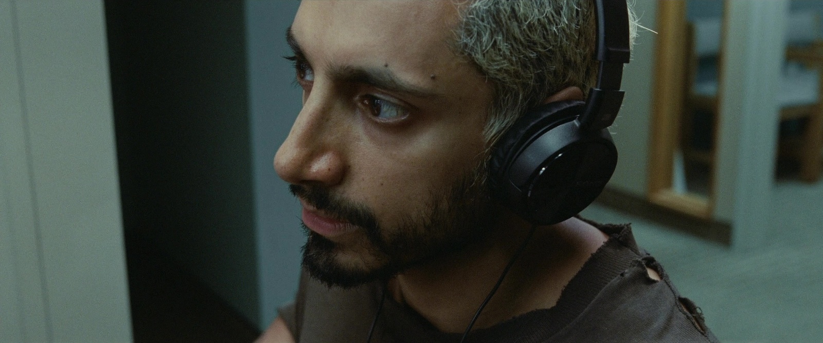 a man with headphones on looking at something