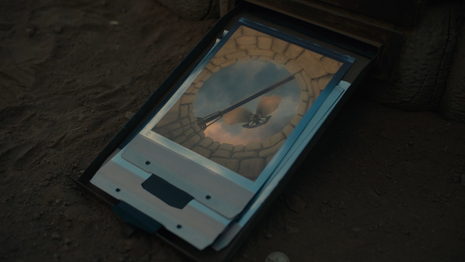 a cell phone laying on the ground in a box