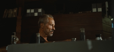 a man sitting at a desk in a dark room