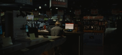 a man sitting at a counter in a store