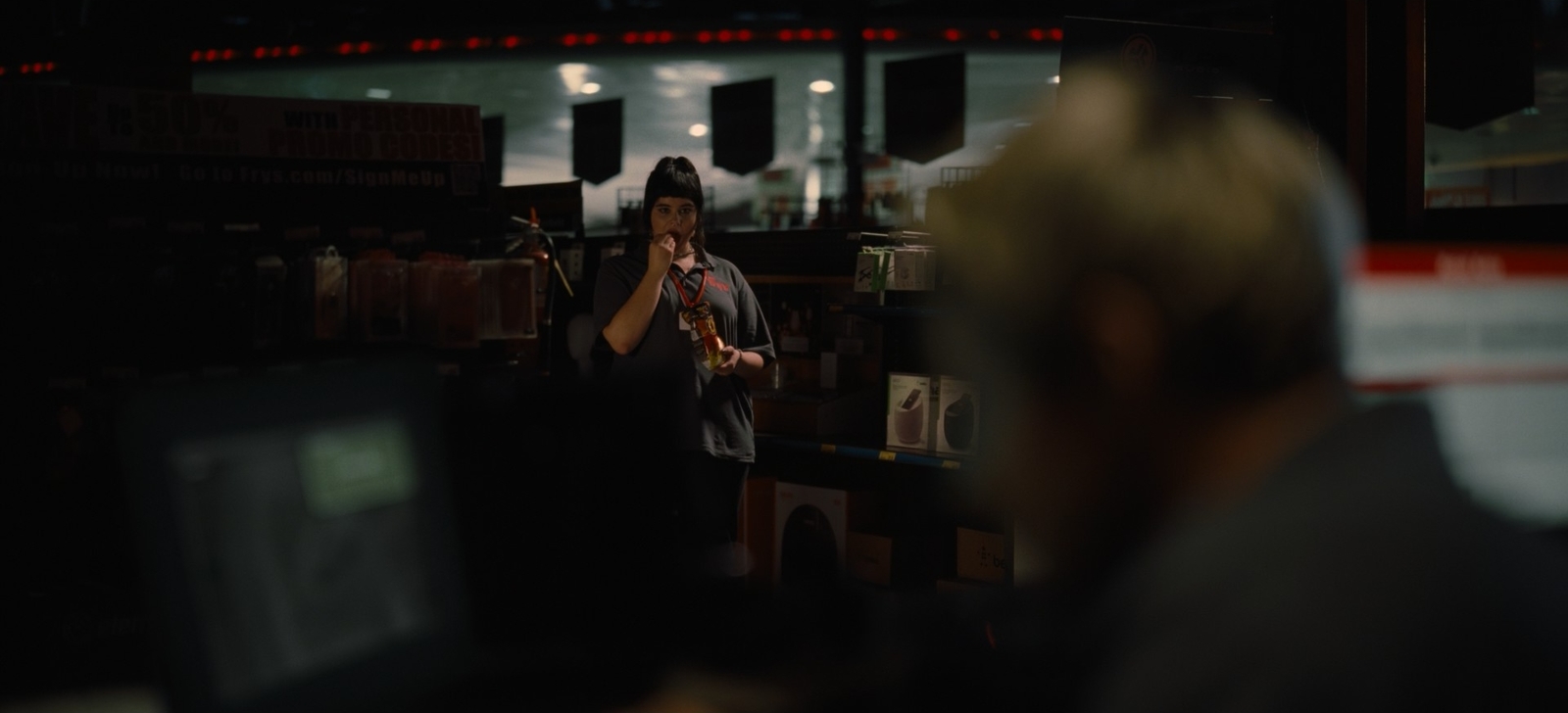 a woman playing a violin in a dark room