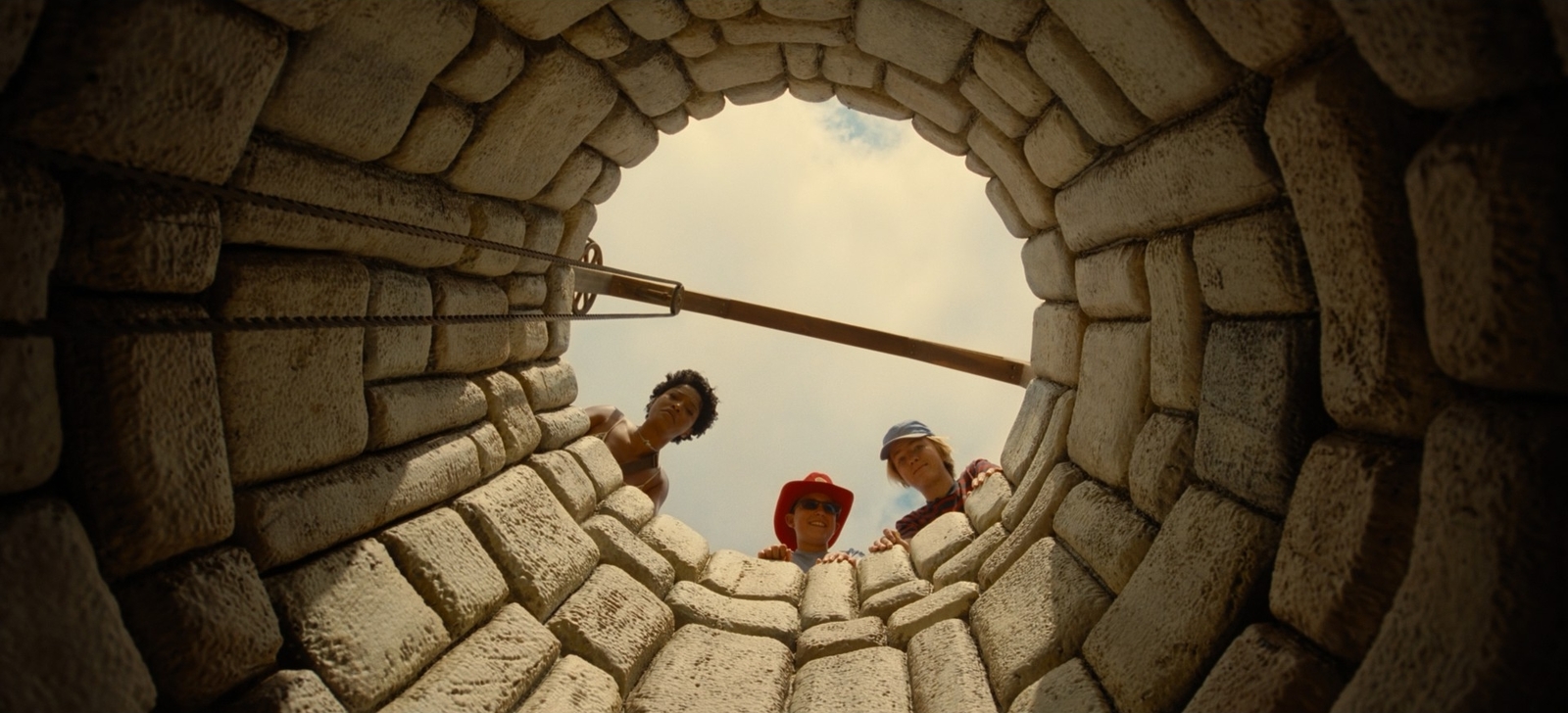 a group of people standing inside of a stone tunnel