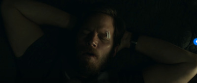 a man sleeping in the dark with his eyes closed