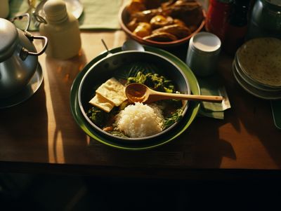 a wooden table topped with a bowl of food