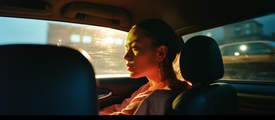 a woman sitting in a car looking out the window