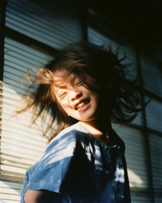 a young girl with her hair blowing in the wind