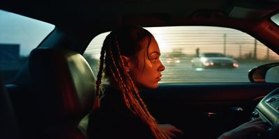 a woman driving a car on a highway