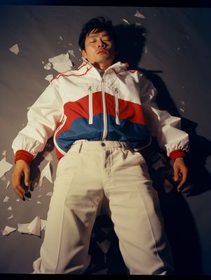 a man laying on the ground with his eyes closed