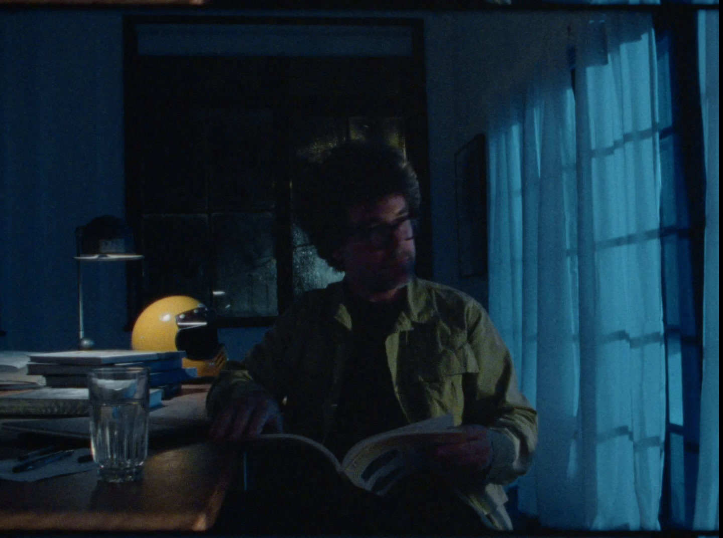 a man sitting at a table reading a book