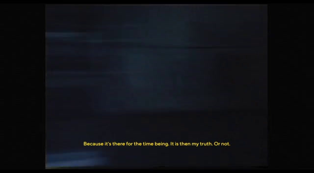 a blurry photo of a black background with a yellow text