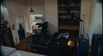 a man standing in a room next to a table