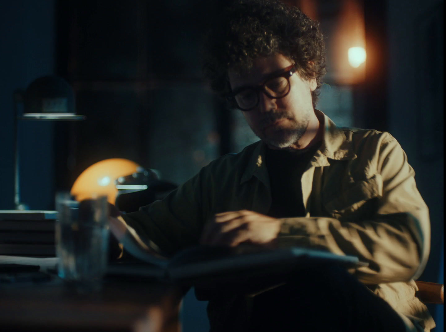 a man sitting at a table with a book