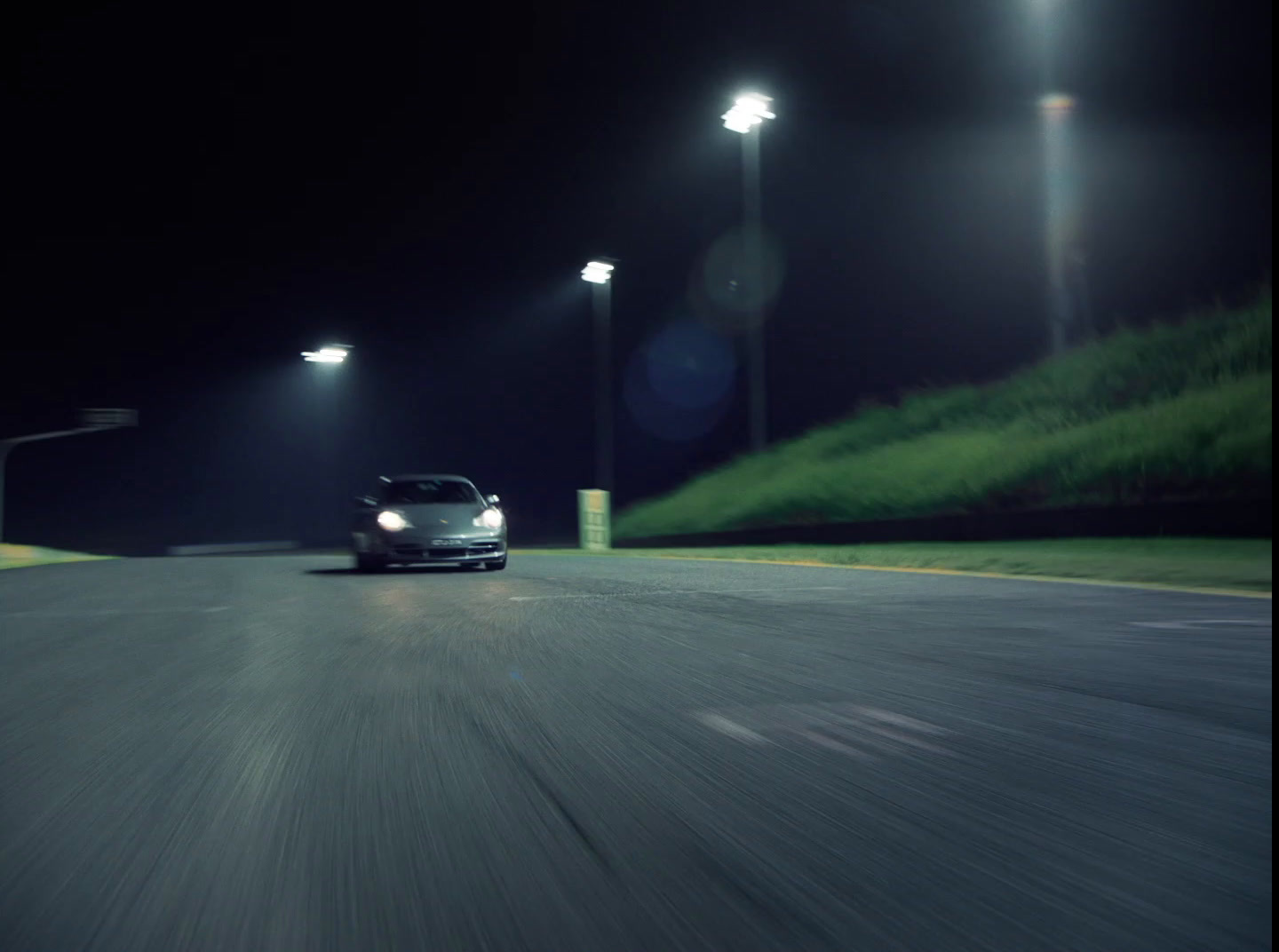 a car driving down a street at night