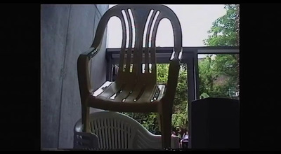 a wooden chair sitting on top of a balcony