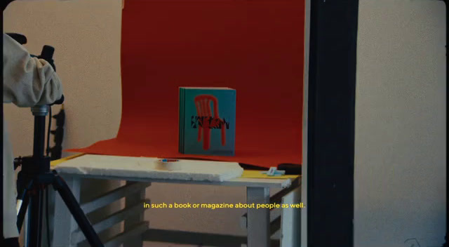 a photo of a chair and a book on a table