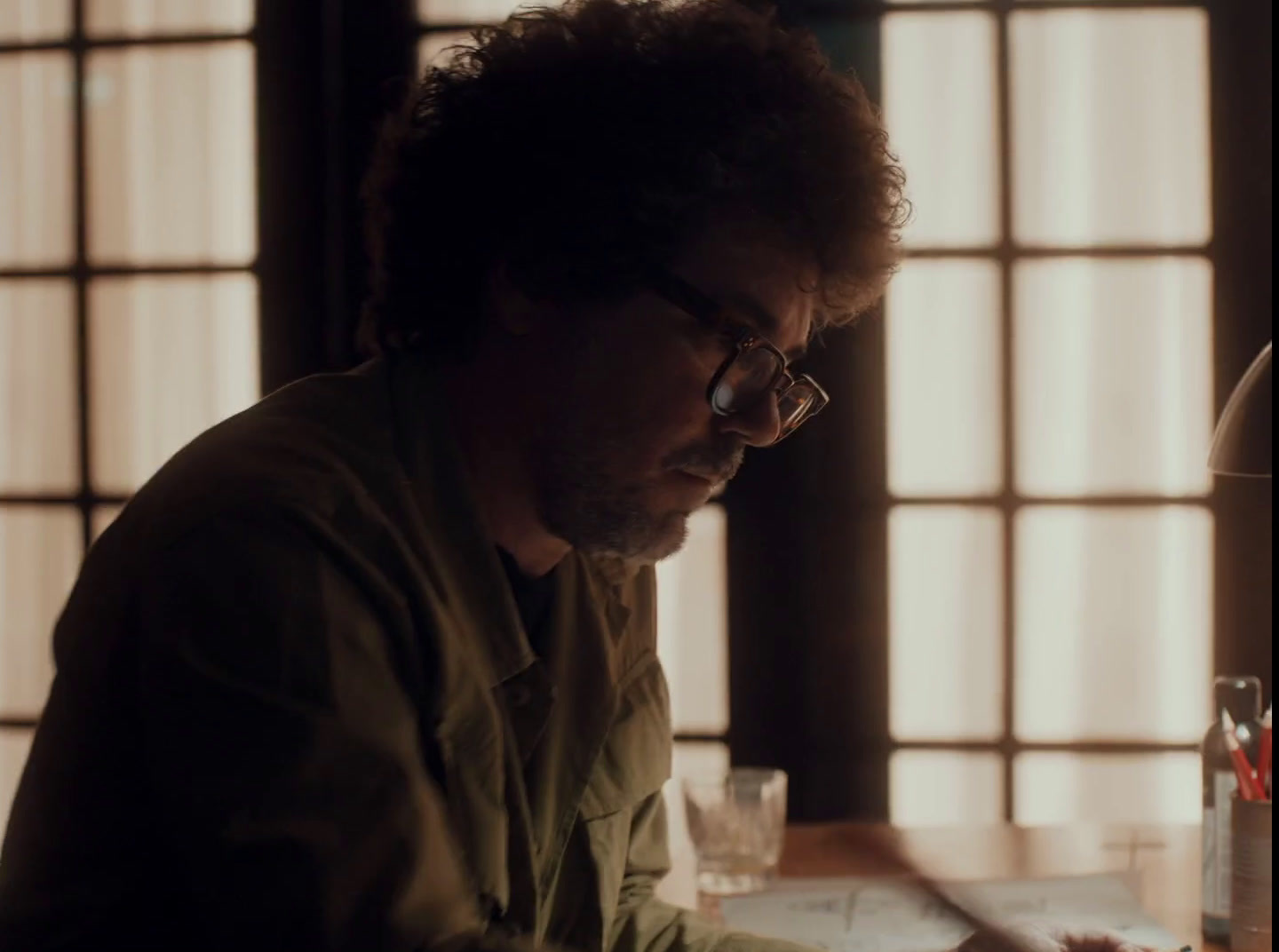 a man sitting at a table in front of a laptop computer