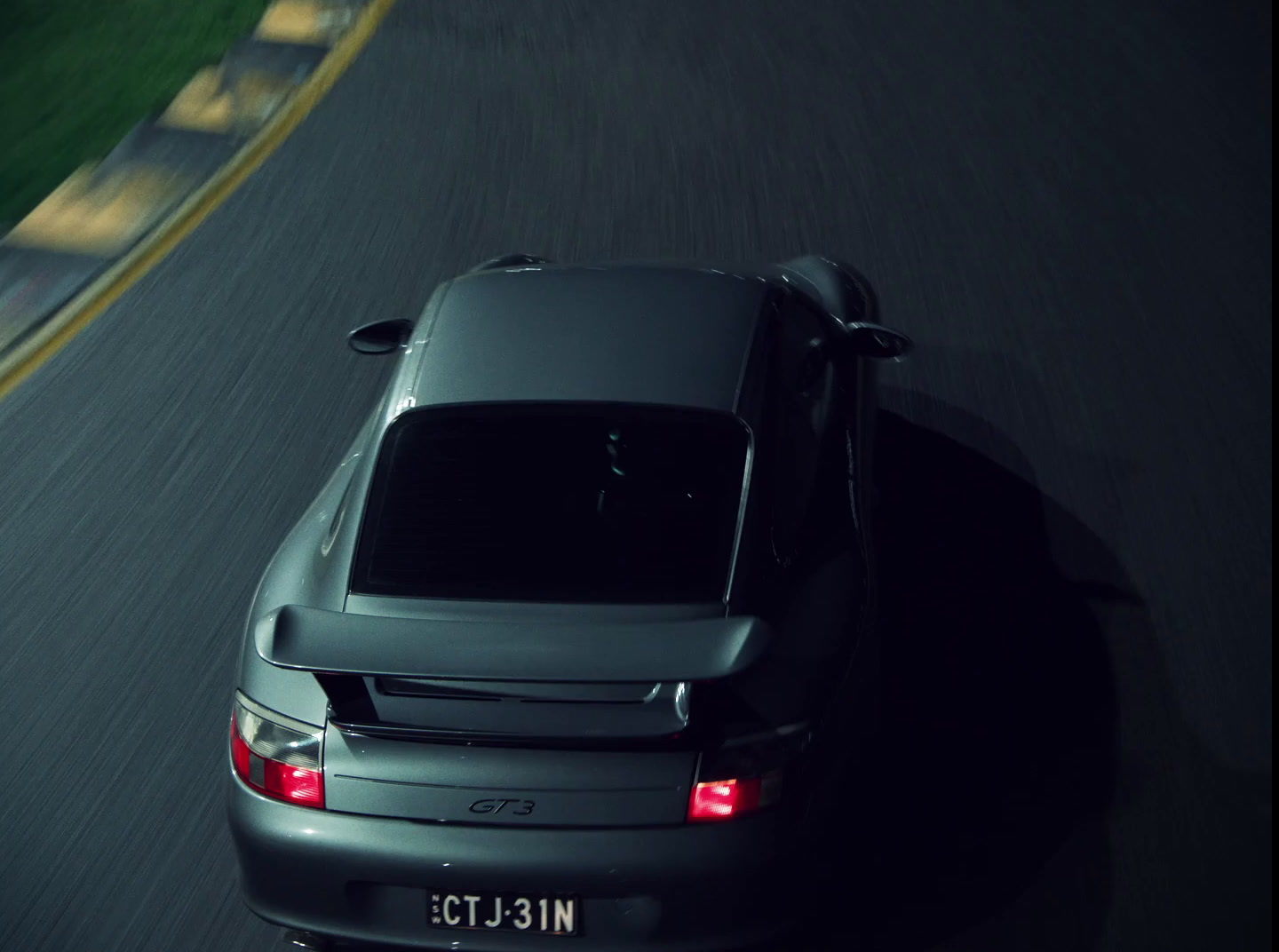 a car driving down a road at night