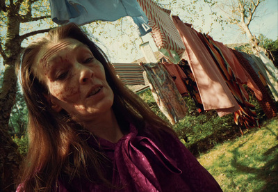 a woman standing in front of a clothes line