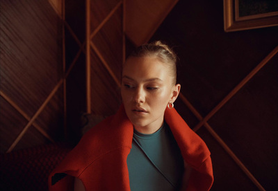 a woman in a red jacket is looking down