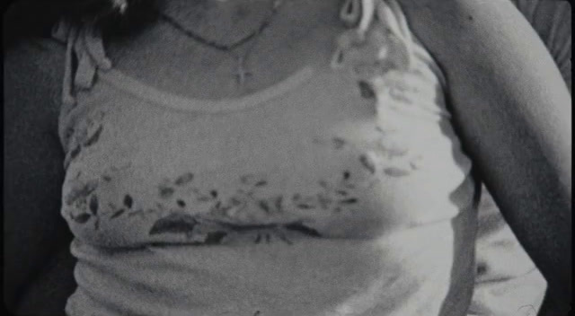 a black and white photo of a woman in a tank top