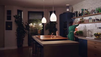 a man standing in a kitchen next to a counter