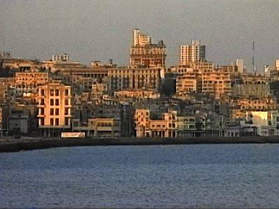 a large body of water with a city in the background