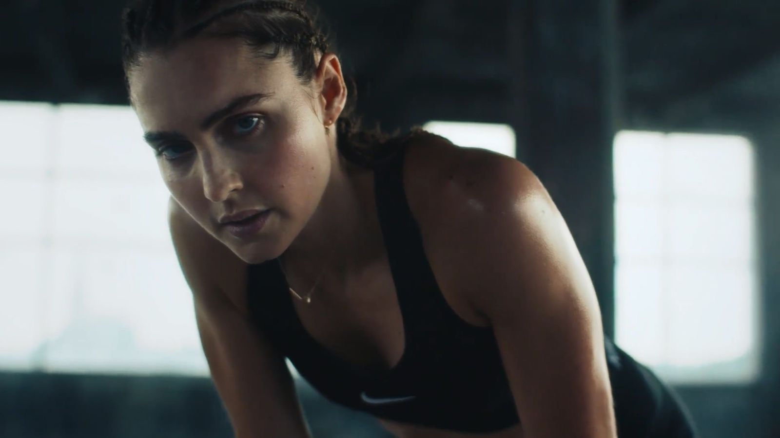 a woman in a black sports bra top crouching down