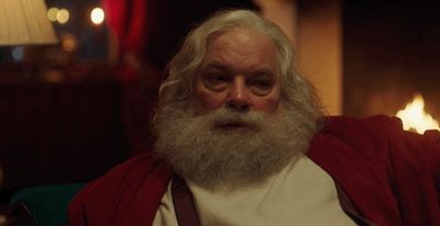 a man with a long white beard wearing a red robe