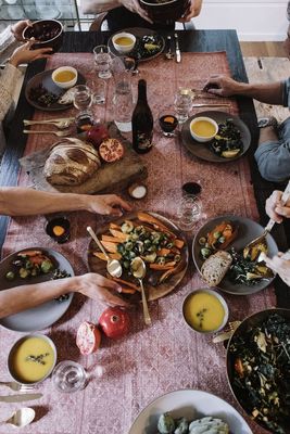 a group of people sitting around a table eating food