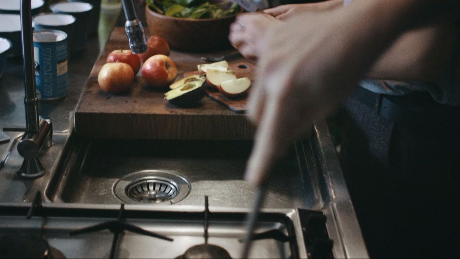 a person cutting apples on a cutting board